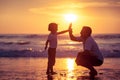 Father and son playing on the beach at the sunset time. Royalty Free Stock Photo