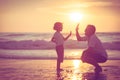 Father and son playing on the beach at the sunset time. Royalty Free Stock Photo