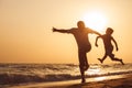 Father and son playing on the beach at the sunset time. Royalty Free Stock Photo