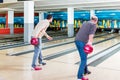 Father and son playing bowling game