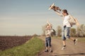 Father and son playing with cardboard toy airplane in the park a Royalty Free Stock Photo