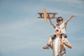 Father and son playing with cardboard toy airplane in the park a Royalty Free Stock Photo