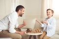 Father and son playing chess and looking at each other at home Royalty Free Stock Photo