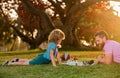 Father and son playing chess lying on grass at lawn park. Fathers Day, love family, parenthood, childhood concept. Child Royalty Free Stock Photo