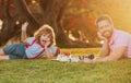 Father and son playing chess lying on grass at lawn park. Games and entertainment for children. Family concept. Fathers Royalty Free Stock Photo