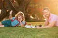 Father and son playing chess lying on grass at lawn park. Games and entertainment for children. Family concept. Fathers Royalty Free Stock Photo