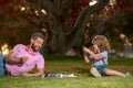 Father and son playing chess outdoor in park. Royalty Free Stock Photo