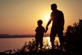 Father and son playing on the coast of lake Royalty Free Stock Photo