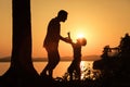 Father and son playing on the coast of lake Royalty Free Stock Photo