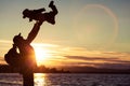 Father and son playing on the coast of lake in the mountains Royalty Free Stock Photo