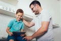 Father and son playing with digital tablet Royalty Free Stock Photo
