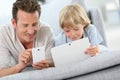 Father and son playing with electronical devices Royalty Free Stock Photo