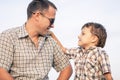 Father and son playing on the field at the day time.