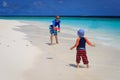 Father and son playing with flying disc at beach Royalty Free Stock Photo