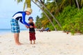 Father and son playing with flying disc at beach Royalty Free Stock Photo