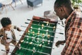 Father and son playing playing foosball