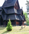 Father and son playing in front of the Gol Church, a stave church originally built in Gol city, but now located in Oslo. Royalty Free Stock Photo