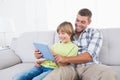 Father and son playing game on digital tablet Royalty Free Stock Photo