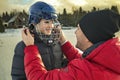 Father and son playing hockey together outside on a lake