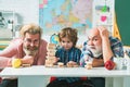 Father and son playing Jenga with grandchild. Elderly man playing his grandson and son. Royalty Free Stock Photo