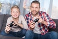 Father and son playing with joysticks Royalty Free Stock Photo