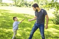 Father and son playing on the meadow.