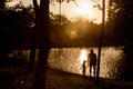 Father and son playing near the lake in the mountains of at the sunset time Royalty Free Stock Photo