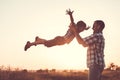 Father and son playing in the park at the sunset time. Royalty Free Stock Photo