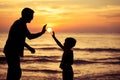 Father and son playing in the park at the sunset time. Royalty Free Stock Photo