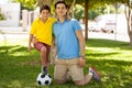 Father and son playing soccer