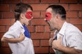 Father and son playing superhero outdoors at the day time. Royalty Free Stock Photo