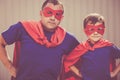 Father and son playing superhero outdoors at the day time. Royalty Free Stock Photo