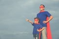 Father and son playing superhero outdoors at the day time. Royalty Free Stock Photo