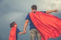 Father and son playing superhero outdoors at the day time. Royalty Free Stock Photo