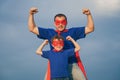 Father and son playing superhero outdoors at the day time. Royalty Free Stock Photo