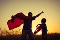 Father and son playing superhero at the sunset time. Royalty Free Stock Photo