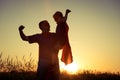 Father and son playing superhero at the sunset time. Royalty Free Stock Photo