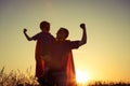 Father and son playing superhero at the sunset time. Royalty Free Stock Photo