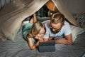 Father and son playing in a teepee tent at home. Royalty Free Stock Photo