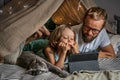 Father and son playing in a teepee tent at home. Royalty Free Stock Photo