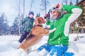 Father with son playing with their dog in deep snow Royalty Free Stock Photo