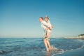 Father with son playing together on sea surf line Royalty Free Stock Photo