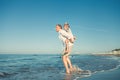 Father with son playing together on sea surf line