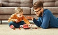 Father and son playing the toys cars at home