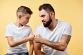 Father and son with pleasant smile give fist bump to each other Royalty Free Stock Photo