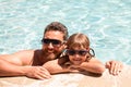 Father and son in pool. Summer vacation concept. Happy family in swimming pool. Pool party. Child with dad. Fathers Day. Royalty Free Stock Photo