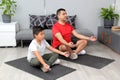 Father and son practice yoga, a mental discipline to improve self-esteem, learn to appreciate their strengths and weaknesses