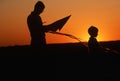 Father and son preparing a kite