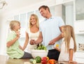 Father & Son Preparing Salad In Modern Kitchen Royalty Free Stock Photo