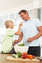 Father & Son Preparing Salad In Modern Kitchen Royalty Free Stock Photo